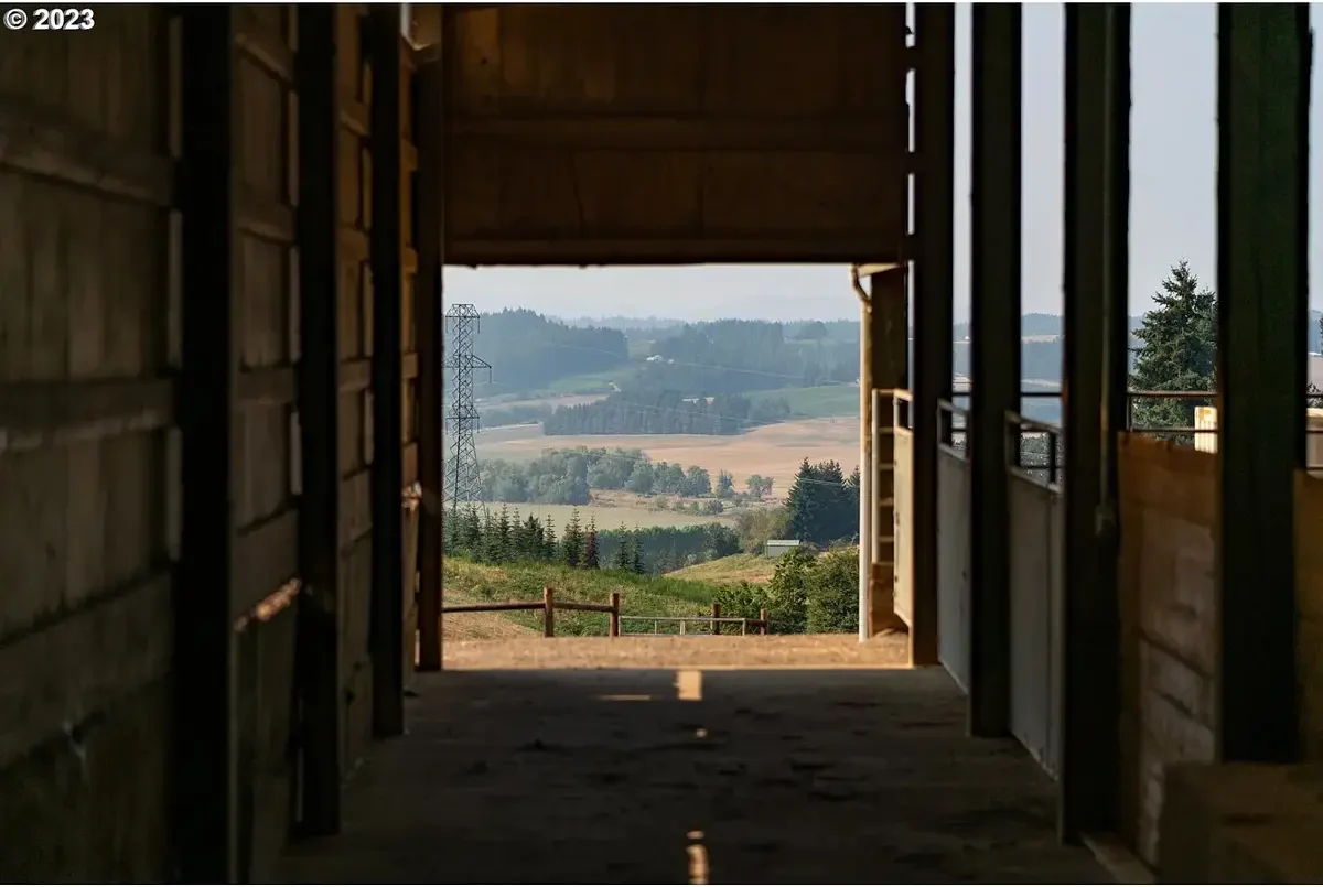 Barn hallway opening onto a valley view